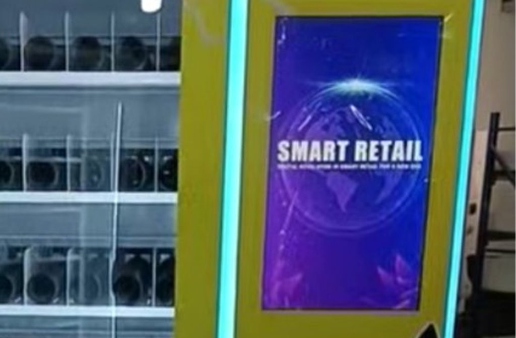 Close view of the vending machine touchscreen next to the stocked product rows